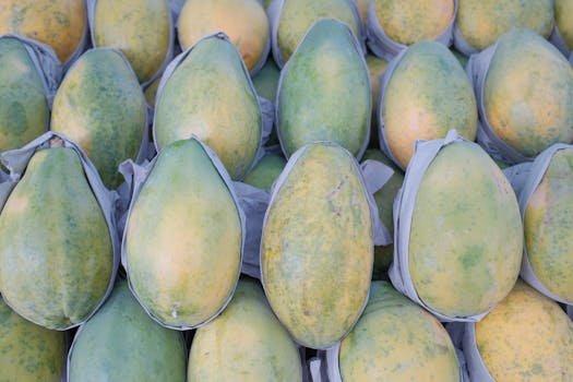 A vibrant collection of ripe green papayas neatly arranged, ideal for healthy eating concepts.